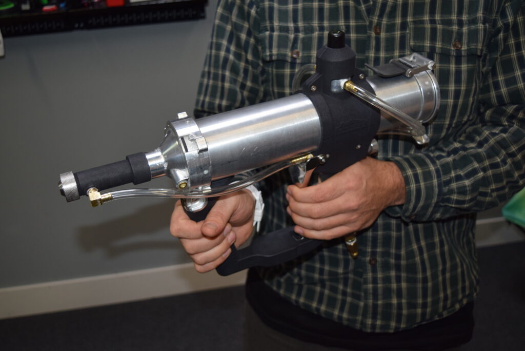 Engineer holds prototype of the Homax Tex Pro texture sprayer